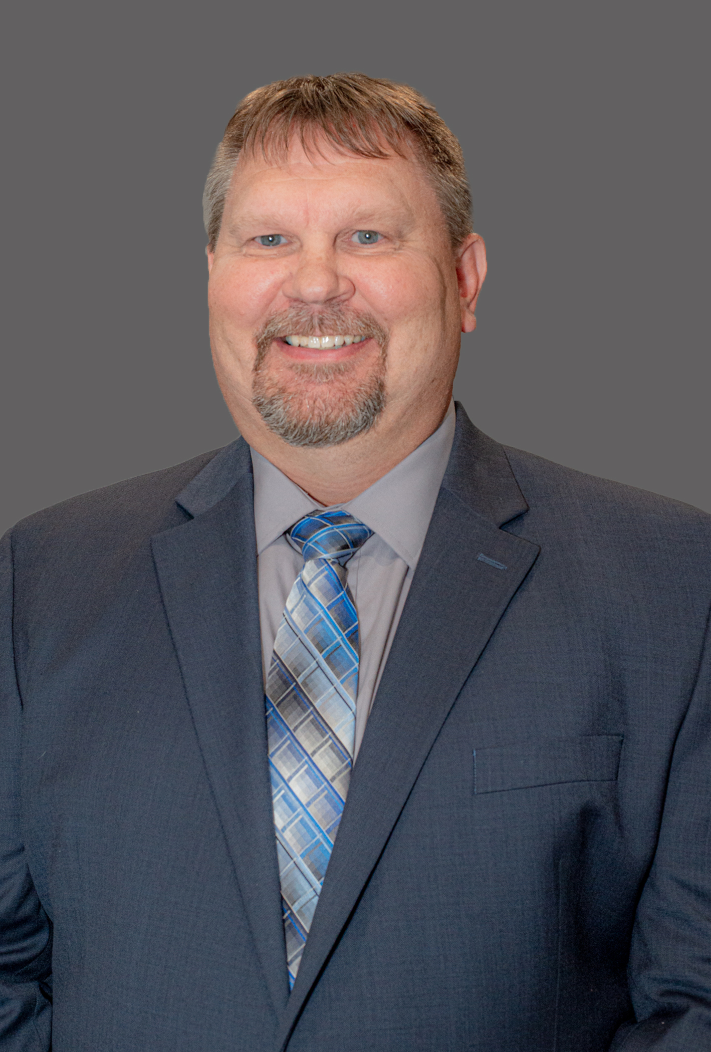 White male in a grey suit and tie, blone hair